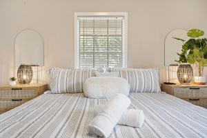 a bedroom with a bed with towels on it at with Arcade and Covered Patio Sleep 9 in this 4 Bedroom 2 Bath Home 5 star host Deer Park TX in Deer Park