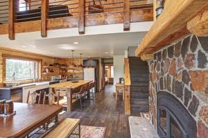 a kitchen and dining room with a stone fireplace at Wildercreek Cabin in Lead