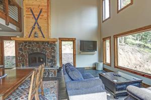 a living room with a fireplace and a table and chairs at Wildercreek Cabin in Lead