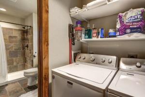 a small bathroom with a washer and a toilet at Wildercreek Cabin in Lead +26 photos