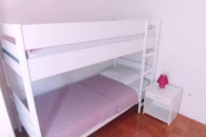 a white bunk bed with a ladder in a room at City Pag Apartment in Pag +41 photos