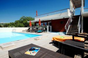 a house with a swimming pool next to a building at Odalys City Antibes Olympe in Antibes