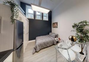 a bedroom with a bed and a table and a chair at Studio in the heart of downtown in Ottawa