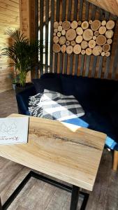 a wooden bench with a pile of wood on it at Карпатське Hygge in Slavske
