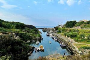 a river with boats docked in the water at The Snug in Amlwch