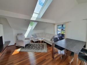 a living room with a couch and a table at Moderne Ferienwohnung Bestlage in Mattsee Salzburg Salzburger Seenland Urlaub am See in Mattsee