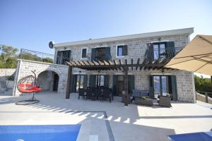 a house with a patio and a swimming pool at Villa Vista Azzurra in Tivat