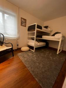 a room with two bunk beds and a rug at Apartamento LOS CORZOS - LA PINILLA in Cerezo de Arriba