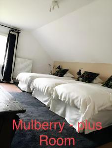 three white beds in a room with the words mulberry room at Kasteelhof van Loppem in Loppem