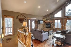 a living room with a couch and a fireplace at Westwinds Lodge in Lead
