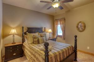 a bedroom with a bed and a ceiling fan at Westwinds Lodge in Lead