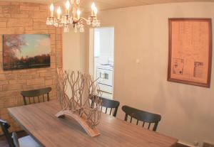 a dining room with a table with chairs and a chandelier at Massive 4 Bed House-Short Walk to Amazing View in Pittsburgh