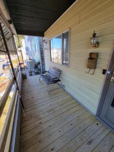 a wooden porch with a bench on a house at Massive 4 Bed House-Short Walk to Amazing View in Pittsburgh