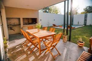 a wooden table and chairs on a patio at Casa Cornu in San Rafael