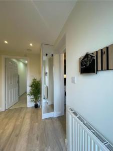 a hallway of a home with a staircase and a hallway at Studio apartment in Bracknell