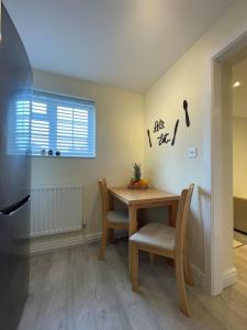 a dining room with a table and two chairs at Studio apartment in Bracknell