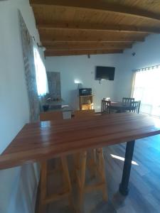 a large wooden table in a living room at Brisas de Atlantida in Santa Clara del Mar
