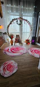 a room with three large pink roses on the floor at Vikendica OM relax in Prijedor