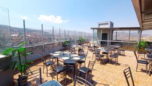 a restaurant with tables and chairs on a balcony at HGA-Turquesa-Spa in La Paz
