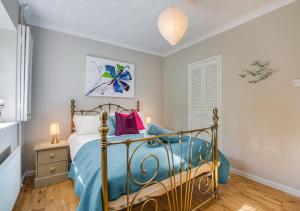 a bedroom with a bed with a blue comforter at Sandy Bottom in Hunstanton