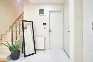 a hallway with a mirror and a potted plant at Privat 3 Bedroom Duplex Apartment at Ulus Beşiktaş in Istanbul