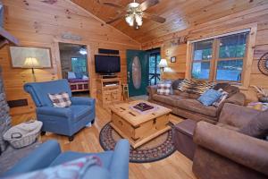 a living room with a couch and a tv at Laurel Creek | Blue Ridge in Blue Ridge