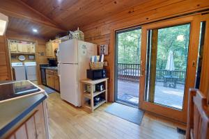 a kitchen with a white refrigerator and a deck at Laurel Creek | Blue Ridge in Blue Ridge