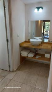 a bathroom with a sink and a mirror at Huapi II in Dina Huapi