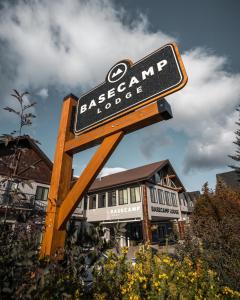 a sign for a restaurant in front of a building at Basecamp Lodge Canmore in Canmore