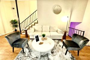 a living room with a couch and two chairs and a table at Fondren Summer Getaway 5 Minutes to Major Hospitals in Jackson