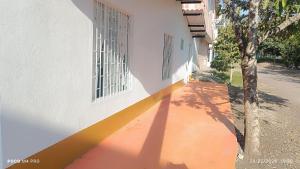 a building with a yellow stripe next to a street at CASA DANY in Guaduas