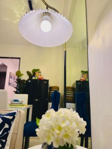 a vase of flowers on a table with a mirror at CasadeIsabel: Elegant 2BR n Cebu/Washing/Netflix in Cebu City