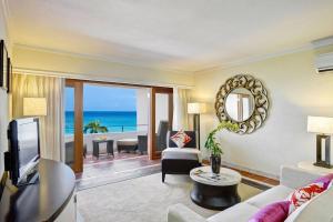 a living room with a view of the ocean at The House by Elegant Hotels - All-Inclusive, Adults Only in Saint James