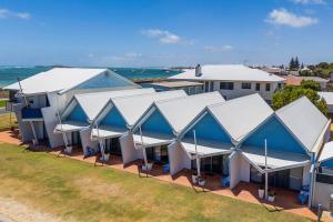 an overhead view of a building with blue and white roofs at Windsurfer Beach Studio in Lancelin