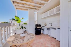 a kitchen and dining room with a table and a sink at Casa do sol nascente Olhão - Boutique Collection in Olhão