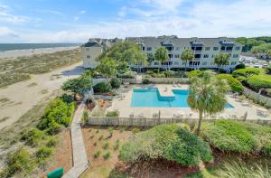 an aerial view of a resort with a pool and a beach at 304 E Port by AvantStay Rooftop Deck Close to Beach in Isle of Palms