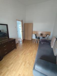 a living room with a couch and a table at Apartments Kalamperovic in Bar