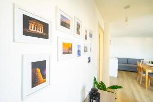 a living room with pictures on a wall at +61 - Sea View Apartment in Agropoli