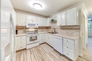 a kitchen with white cabinets and white appliances at Princeville Condo with Private Sauna about 2 Mi to Beach in Princeville