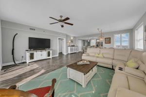 a living room with a couch and a flat screen tv at Ariel Dunes II 1301 in Destin