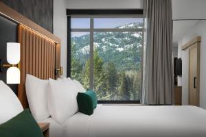 a hotel room with a bed and a large window at SpringHill Suites by Marriott Sandpoint in Sandpoint