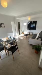 a living room with a couch and a tv at TIERRA Alojamientos in Salta