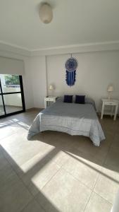 a bedroom with a large bed with blue pillows at TIERRA Alojamientos in Salta