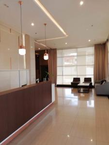 a living room with a couch and chairs in a building at Studio 2205 at Centrio Tower CDO in Cagayan de Oro