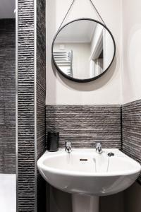 a bathroom with a sink and a mirror at Sweet Ness River Flat, Inverness City in Inverness