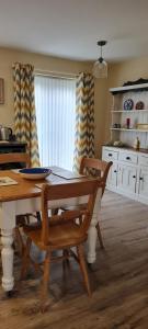 a dining room with a table and chairs and a kitchen at Manby Fields, Manby in Louth