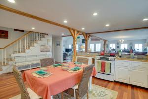 a dining room with a table and a kitchen at Beautiful Aquinnah Home Ocean View, Walk to Beach in Lobsterville