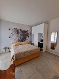 a bedroom with a bed with a painting on the wall at Nyx Lilura Foresteria Lombarda in Seriate