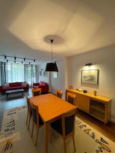 a living room with a dining room table and a couch at Cozy Skopje House in Skopje