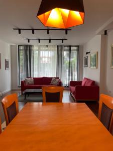 a living room with a table and a couch at Cozy Skopje House in Skopje